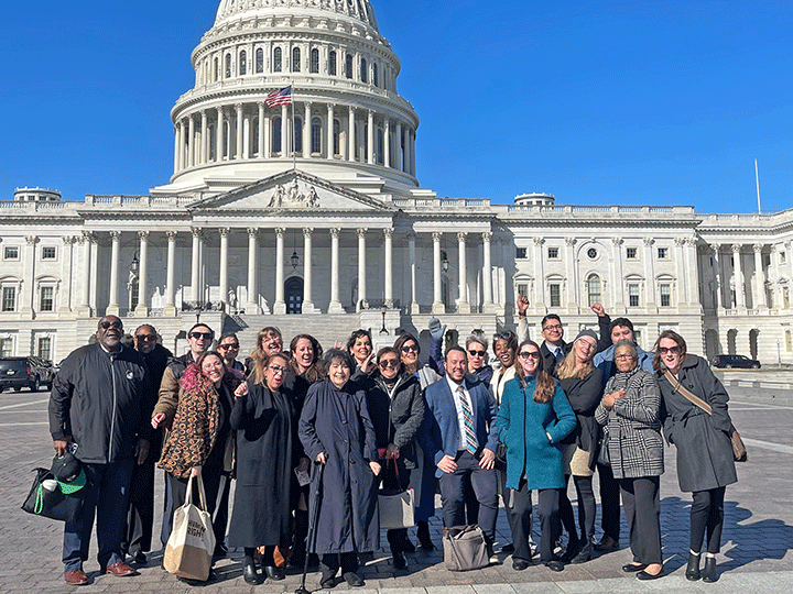 Advocacy day participants pose in front of the U.S. Capitol