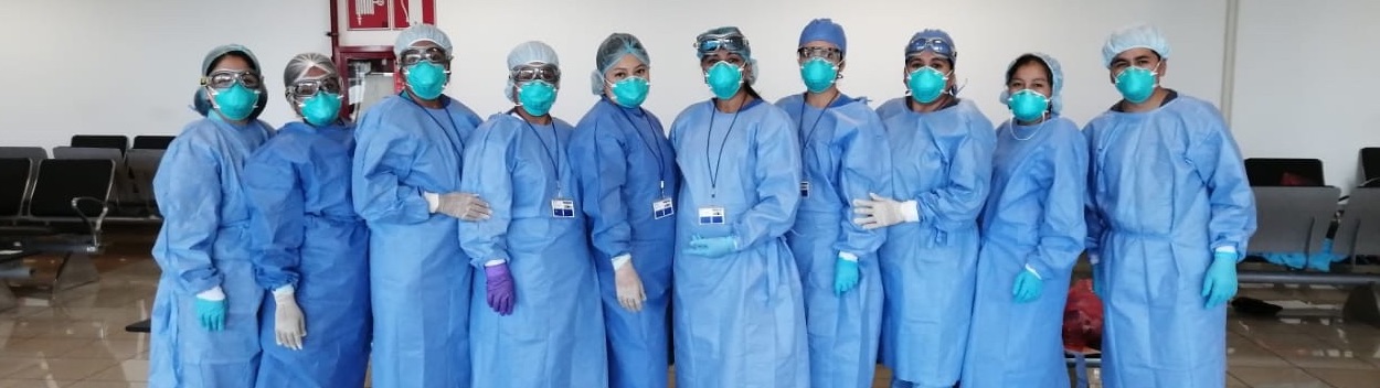 Clinicians from Socios En Salud (PIH in Peru) line up in protective gear