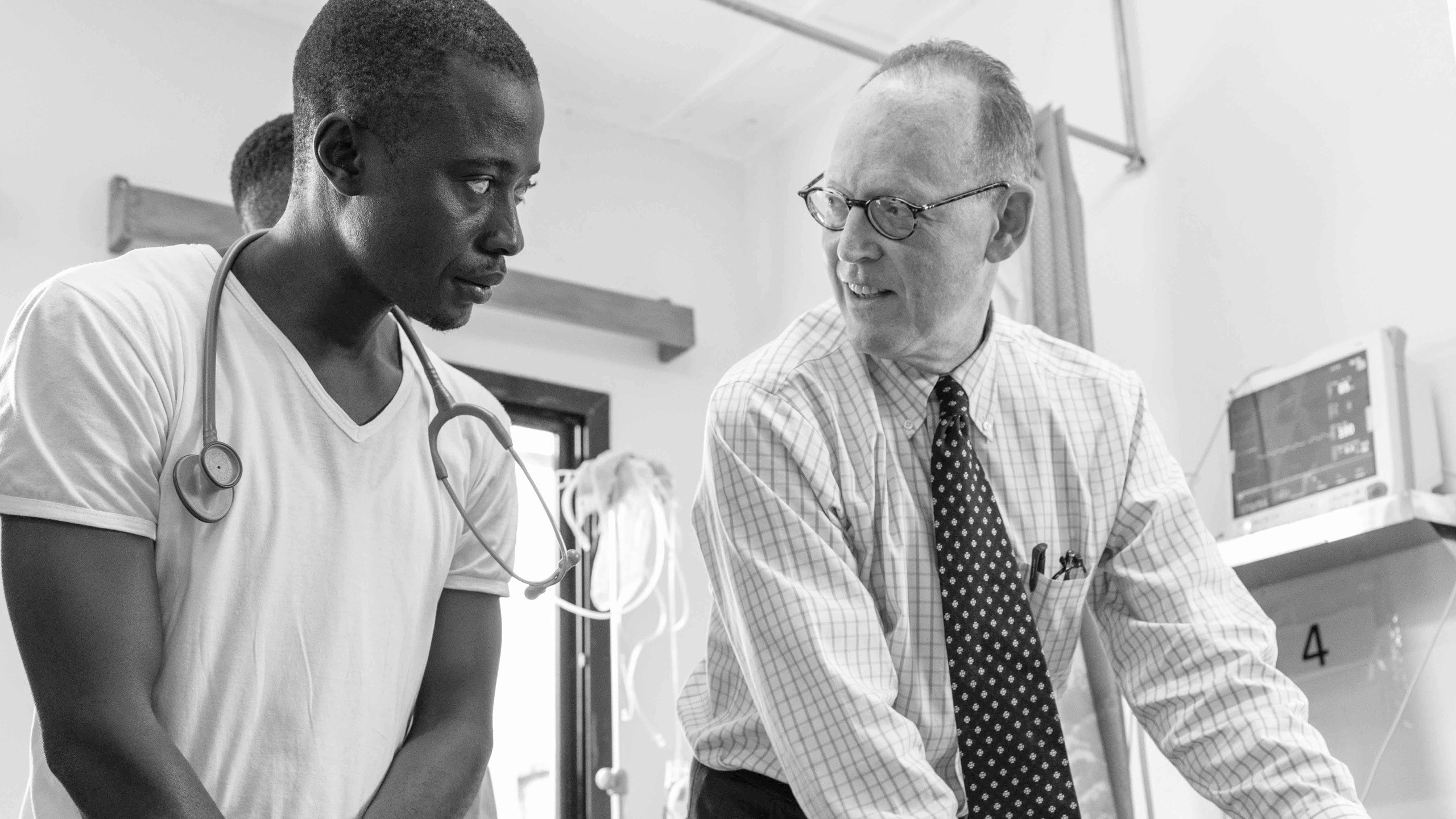Dr Paul Farmer in conversation with a fellow clinician in Sierra Leone