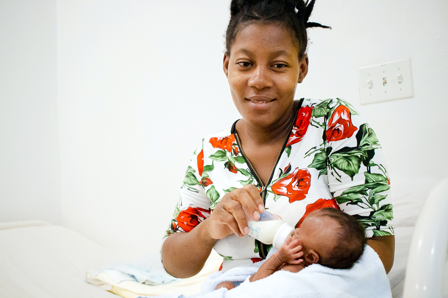  a new mom at Kay Manmito, feeds her twin girls. MIREBALAIS, HAITI 