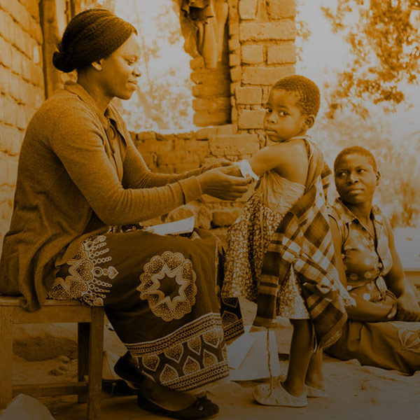 Annie Jere visits with Milica Steven and her three children at their home in Neno, Malawi