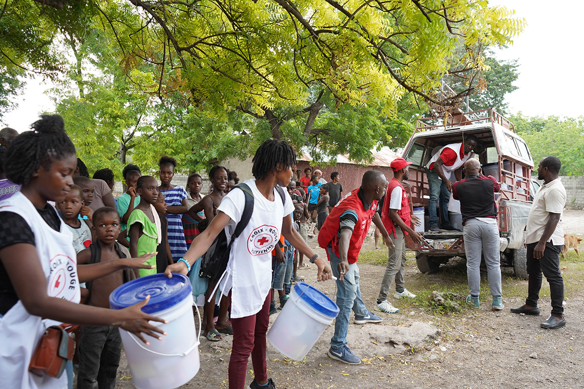 Relief workers loading emergency supplies into a vehicle