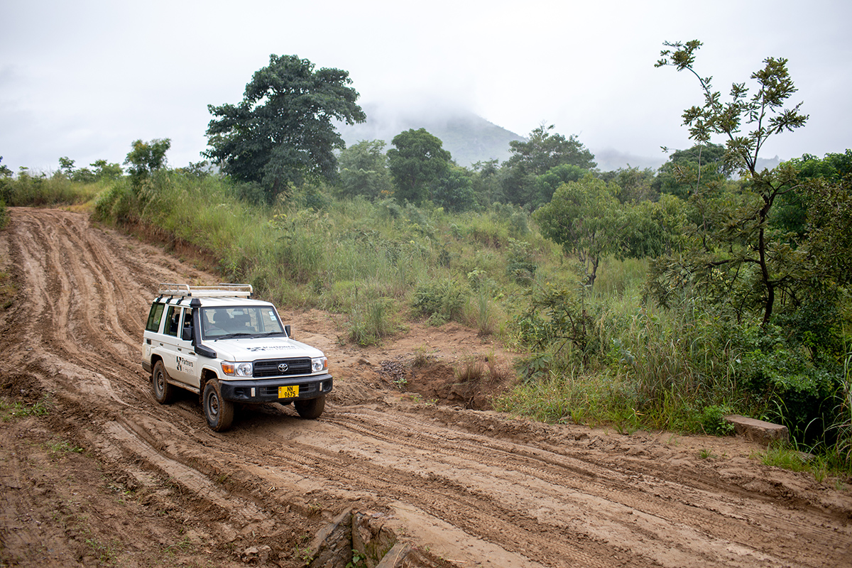 A team of health workers driving on rain damaged roads