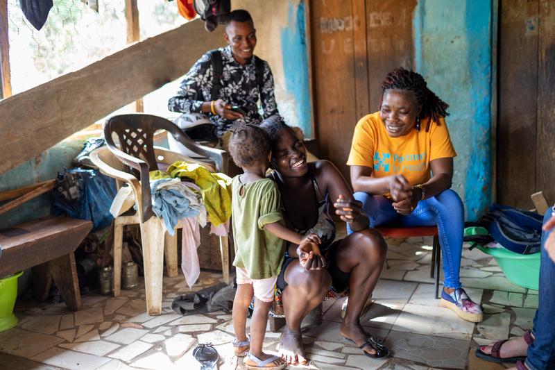 Community Health Worker Supervisor Mabel Koroma makes a home visit to Mariatu Kamara, 24, and her daughter, 2, in Kono District, Sierra Leone.