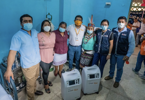 PIHers posing in front of two oxygen concentrators 