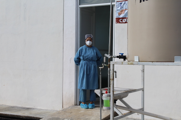 woman standing in protective healthcare gear