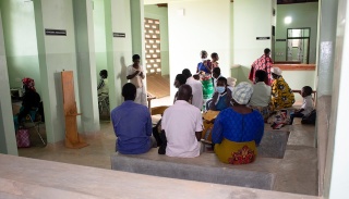 People chat in the waiting area of the new integrated care building in Neno, Malawi