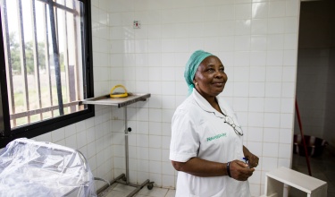 Sister Agnes Matturie, midwife in charge of managing the maternity ward at Koidu Government Hospital in Sierra Leone, stands in the ward's upgraded operating room.