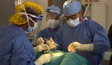 Dr. Gerald Ekwen, right, performs surgery at J.J. Dossen Hospital in Liberia
