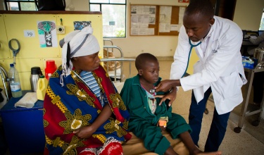 Dr. Cyprien Shyirambere examines 6-year-old boy at the Butaro Cancer Center of Excellence