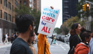 protestor in New York City marches for univeral health care
