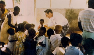 Tom White greeting children in a clinic in Cange, Haiti