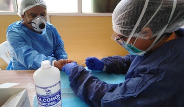 health professionals in Peru conduct a rapid diagnostic test for COVID-19