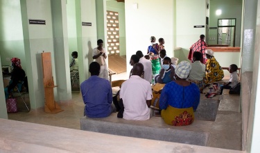 People chat in the waiting area of the new integrated care building in Neno, Malawi