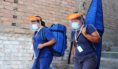 Health care workers from Socios En Salud, as PIH is known in Peru, carry the "Backpack TB" machine.