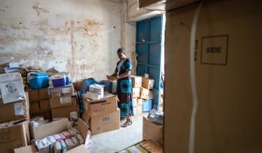 Vicky Reed, director of nursing for PIH Sierra Leone, checks PPE and other COVID-19 supplies 