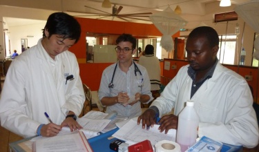 Dr. Paul Park, left, at work in Rwanda 