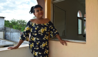 Alondra Esquinca smiles as she stands on a balcony overlooking Jaltenango, where Partners In Health works, in Chiapas, Mexico