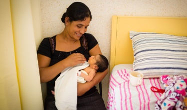 A patient, Debora Sanchez, holds her 5-day-old son at Casa Materna.