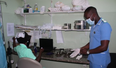 Isaac Mphande prepares to assist a patient in the family planning room at Neno District Hospital.