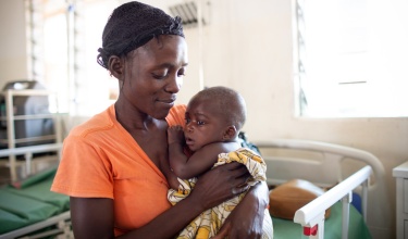 Chisomo Tigone, 7 months, is held by his mother, Flora Tigone, while undergoing treatment for severe malaria in Lisungwi, Malawi.