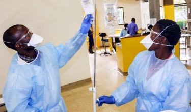 nurses in Rwanda prepare IV fluid for cancer patients