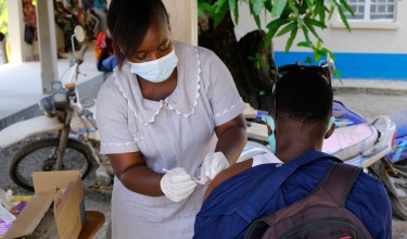 Sylvia Y. Kamara, a nurse with Sierra Leone's Ministry of Health, administers a COVID-19 vaccine in March 2021.