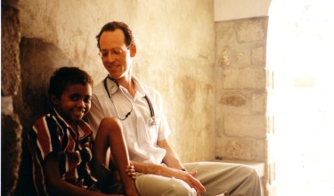 Dr. Paul Farmer with a young patient in Haiti