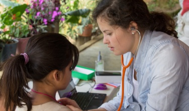 Andrea Jiménez examines a young patient during her year of service in Matasano, a rural community in Chiapas, Mexico.