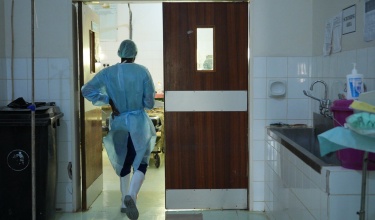 A health worker walks into an operating room in Malawi.