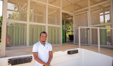 Roosevelt Jean, the Thomonde Health Center administrator, smiling on a tour of the Thomonde Oxygen Production Center.