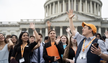 Following the weekend's Training Institute, Fynn Crooks, PIH advocacy senior community organizer, hypes up members of Engage ahead of their Hill Day with over 170 meetings with Congress.